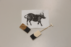 牛の版画と鍬鋤の模型の写真